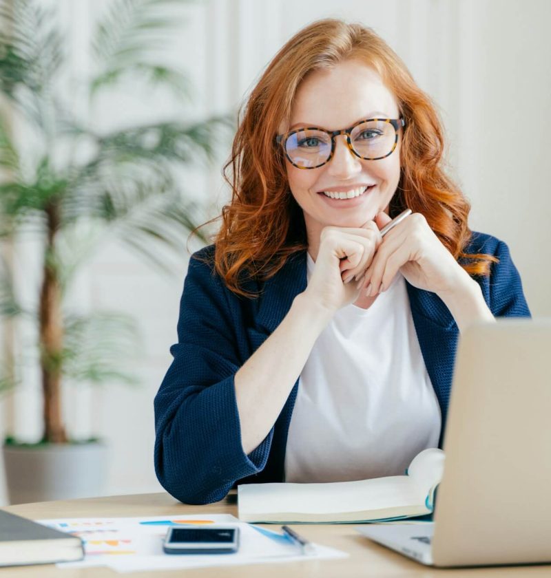 pleased-cheerful-female-economist-develops-financial-startup-project-poses-in-office-interior.jpg
